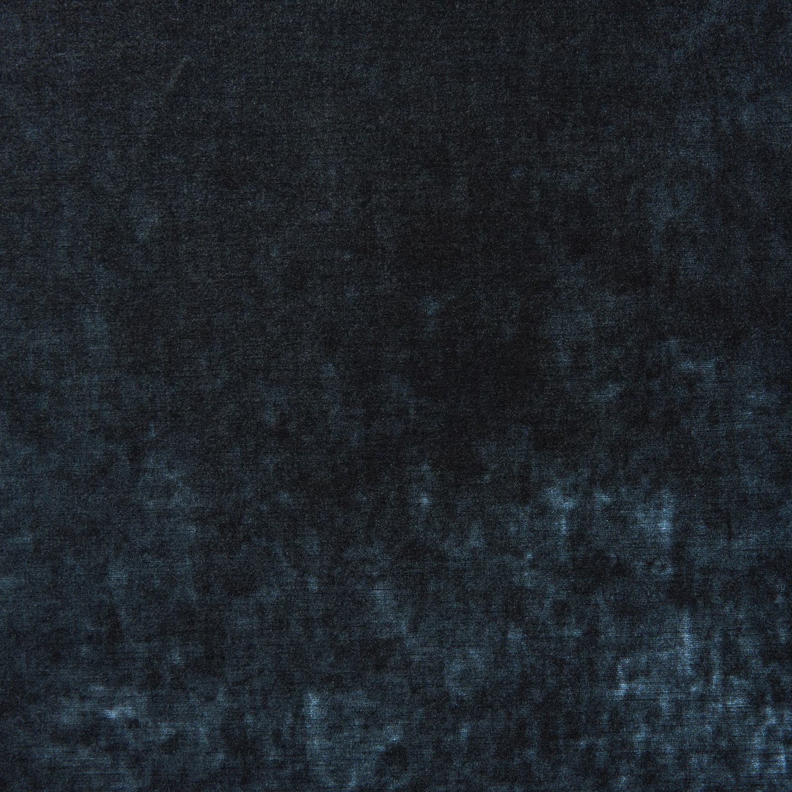 Close-up of dark indigo blue velvet with mottled pile and subtle blue highlights