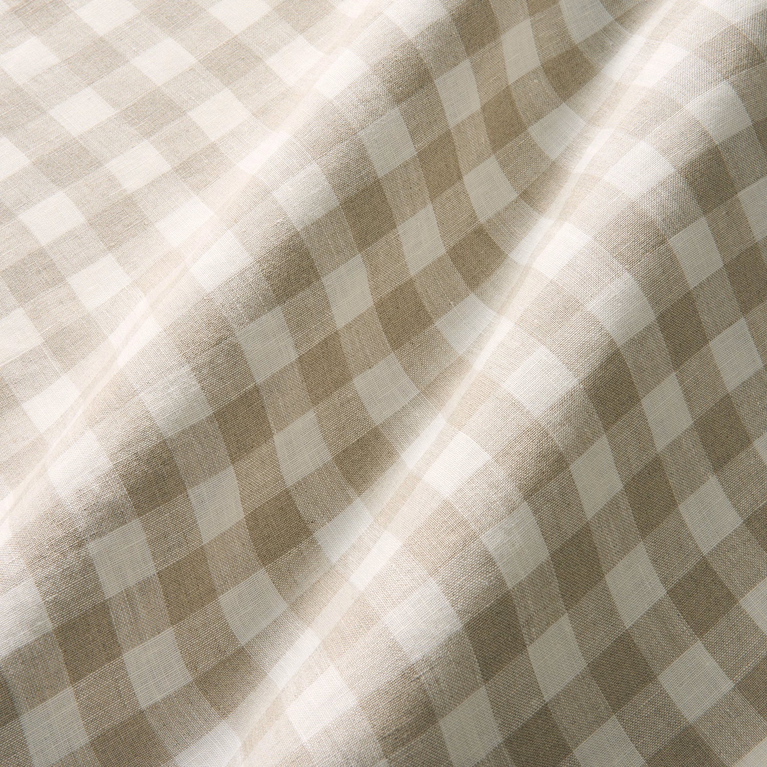 Warm oatmeal and cream checked linen with a softly slubbed, folded surface