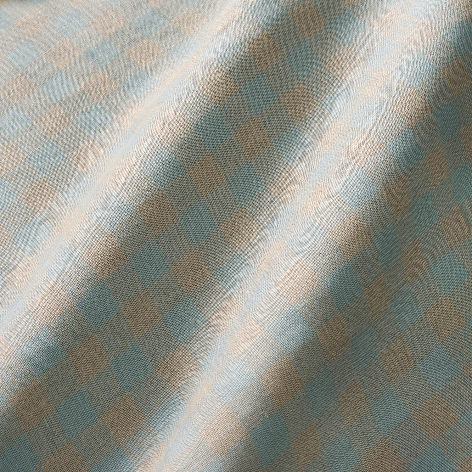 Muted sky-blue and aqua linen with taupe-lilac checks catching the light