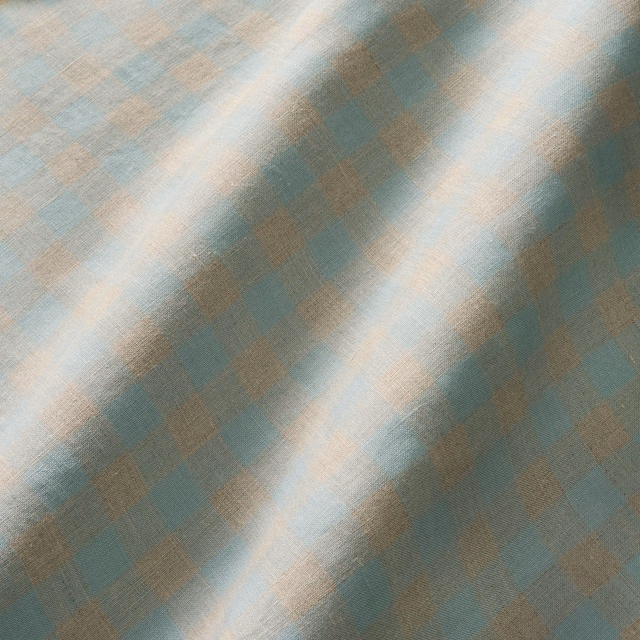 Muted sky-blue and aqua linen with taupe-lilac checks catching the light