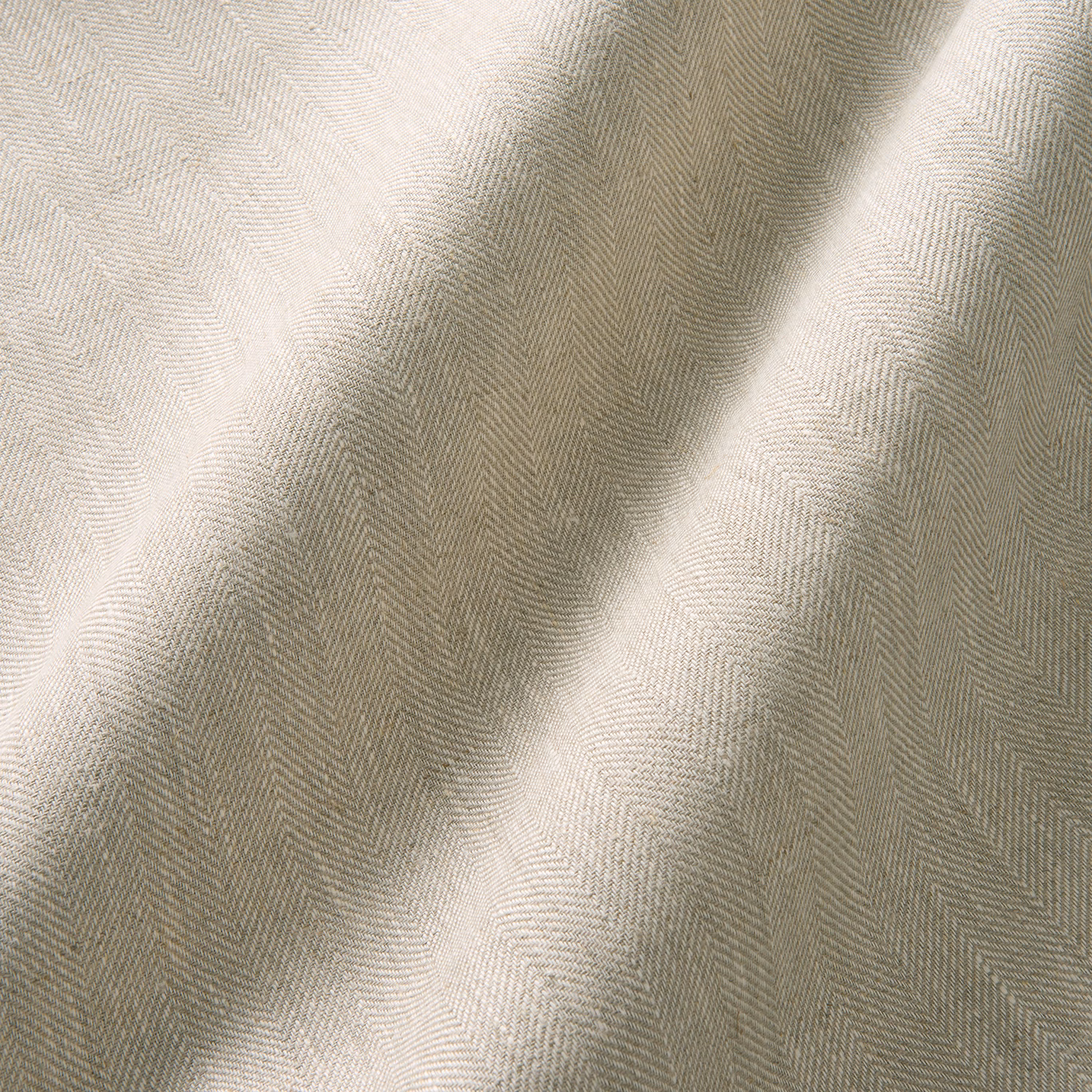Warm cream linen curtain swatch with fine herringbone weave and softly shaded folds
