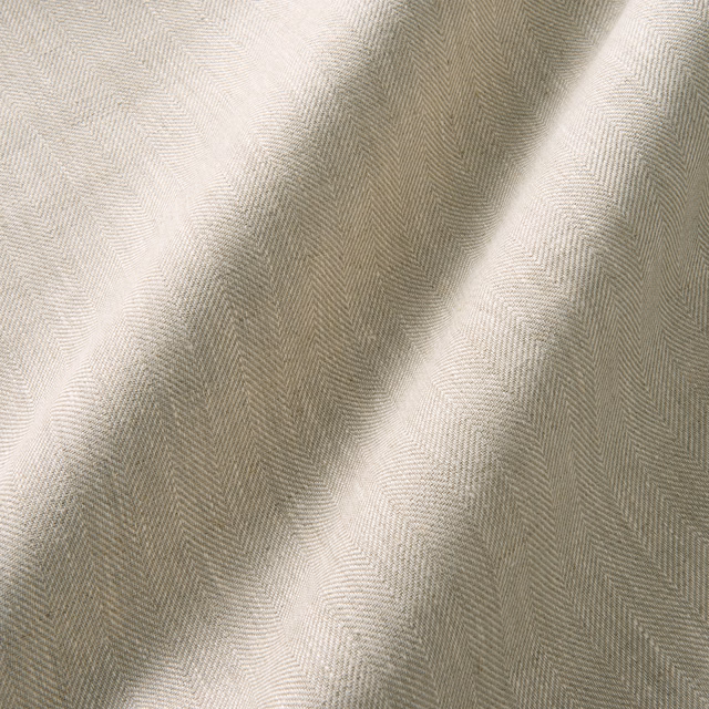 Warm cream linen curtain swatch with fine herringbone weave and softly shaded folds
