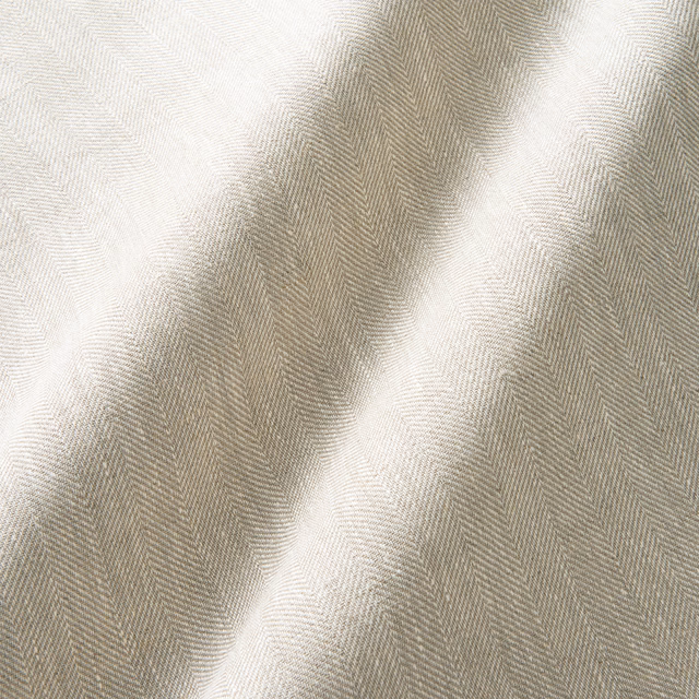 Warm oatmeal linen curtain fabric with fine herringbone weave and softly shaded folds