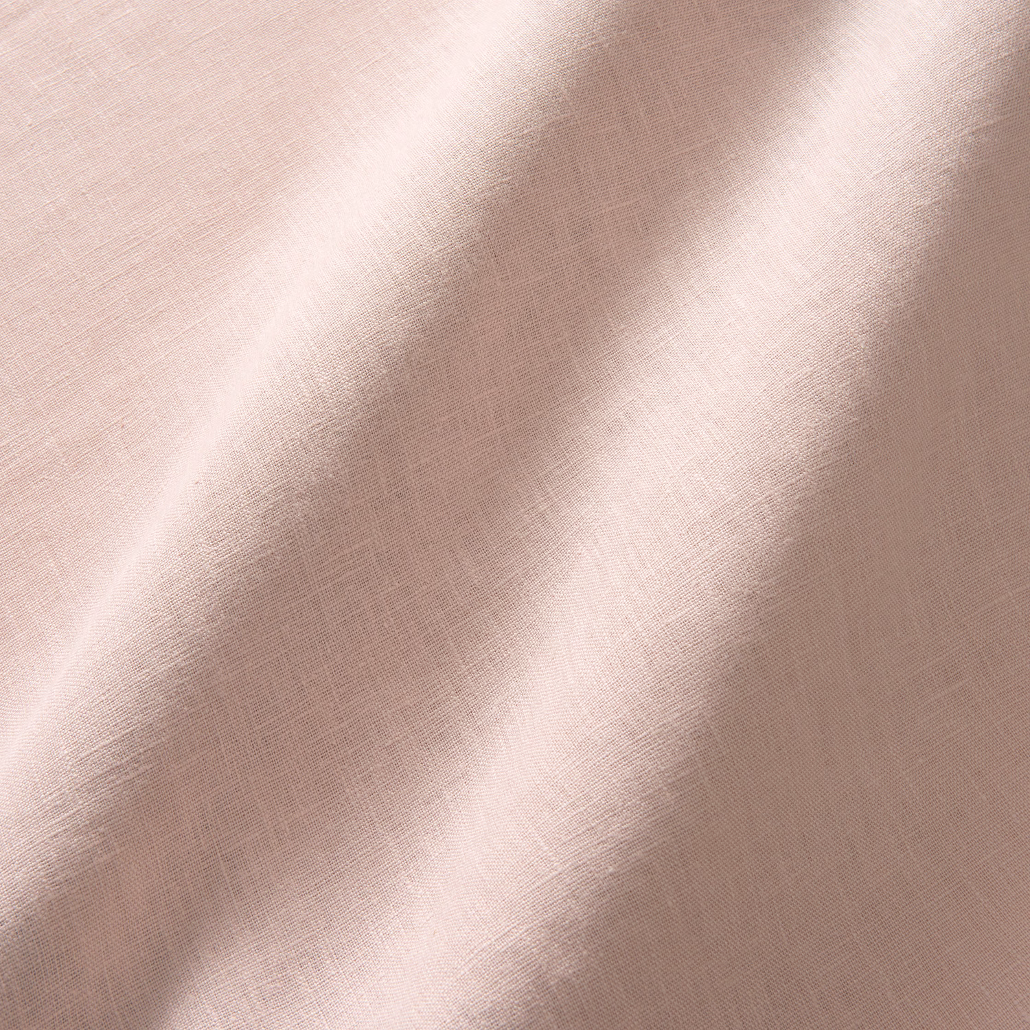 Dusty blush pink linen with fine crossweave texture and softly shaded curtain-like folds