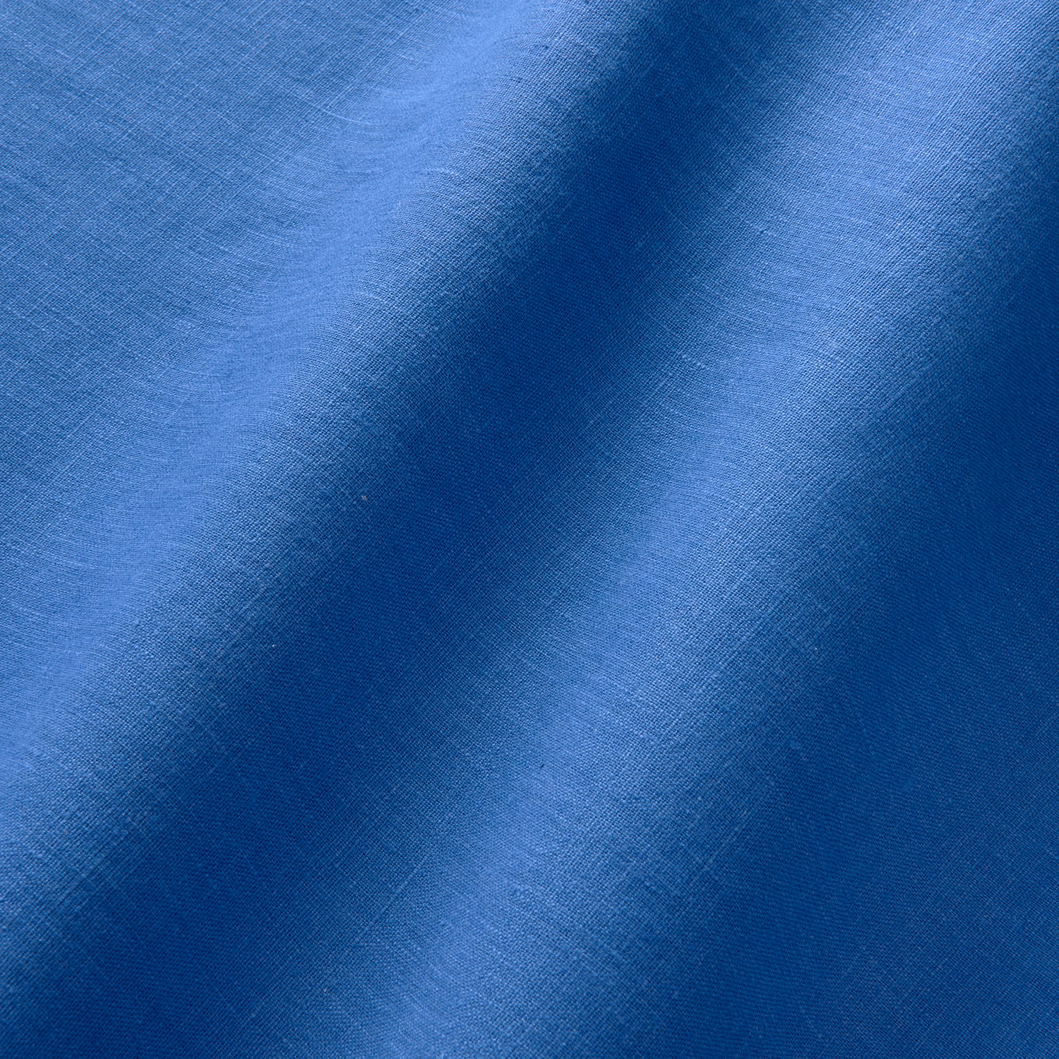 Close-up of cobalt blue linen with fine crosshatch weave and tonal folds