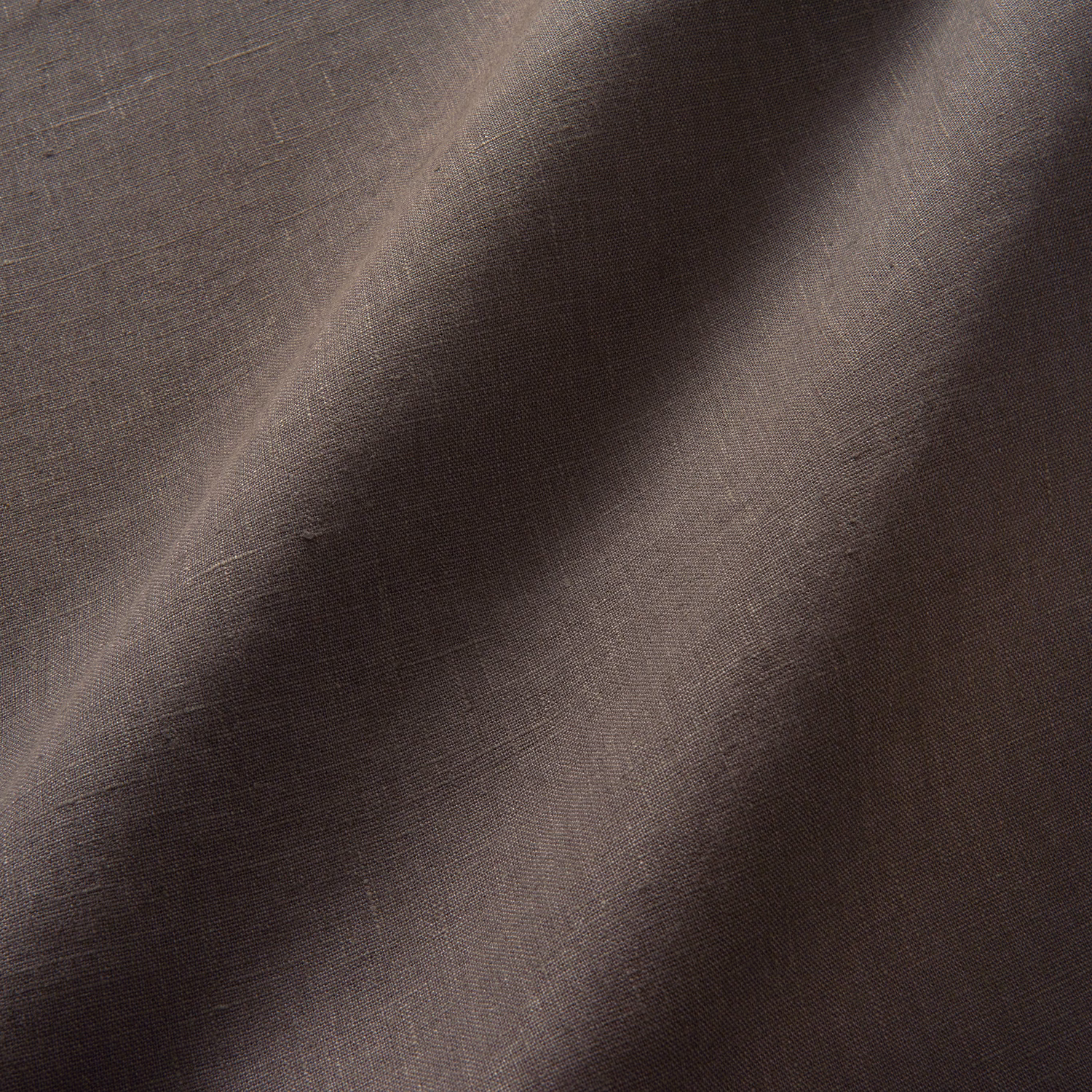 Close-up of dark chocolate-brown linen weave with softly shifting tonal highlights