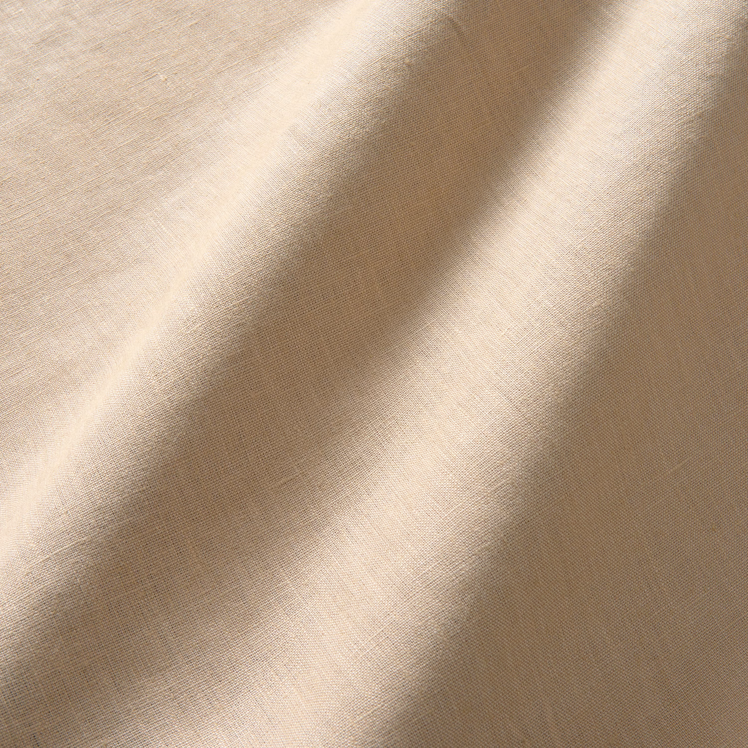 Warm latte-beige linen with fine plain weave and softly rippling folds