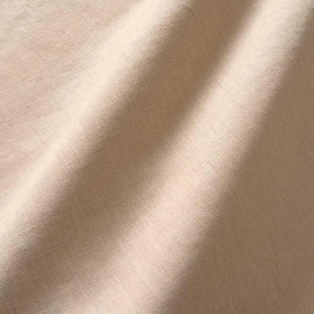 Warm latte-beige linen with fine plain weave and softly rippling folds