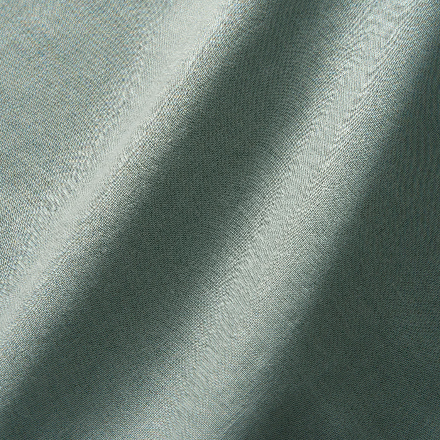 Muted lichen-green linen with fine plain weave and softly shaded draped folds