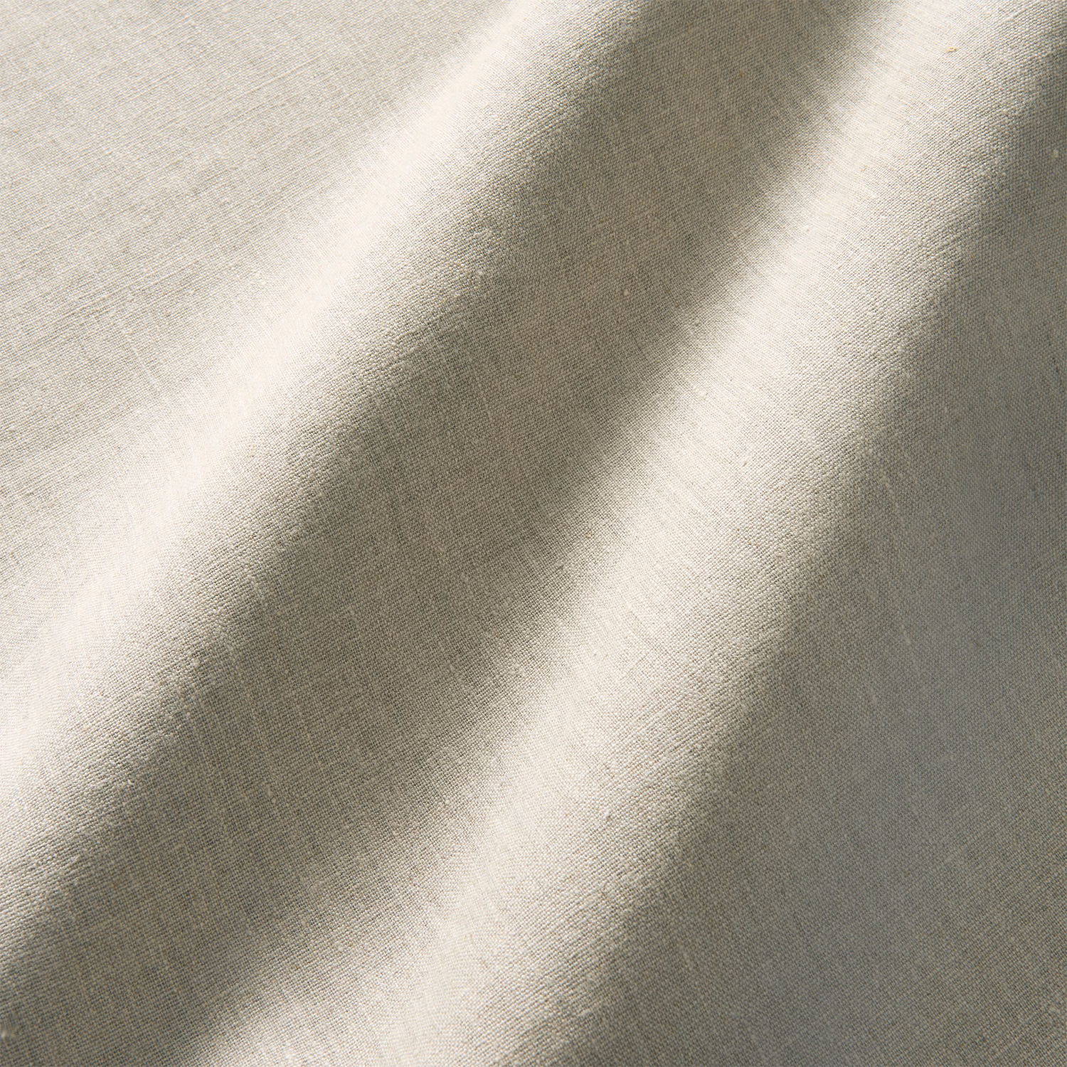 Pale greige plain linen with fine crossweave and diagonal light across the swatch