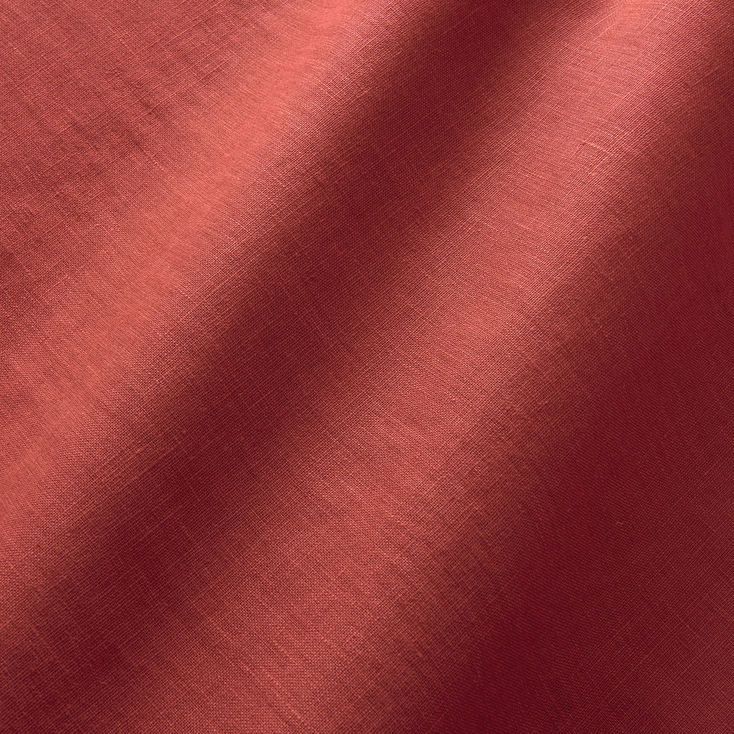 Scarlet red plain linen with coral highlights and burgundy shadowing across its fine weave
