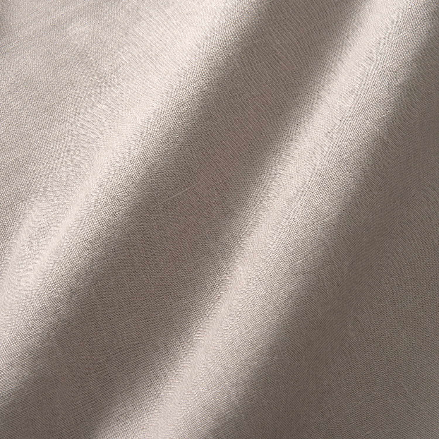 Close view of muted taupe-grey linen plain weave with soft diagonal folds