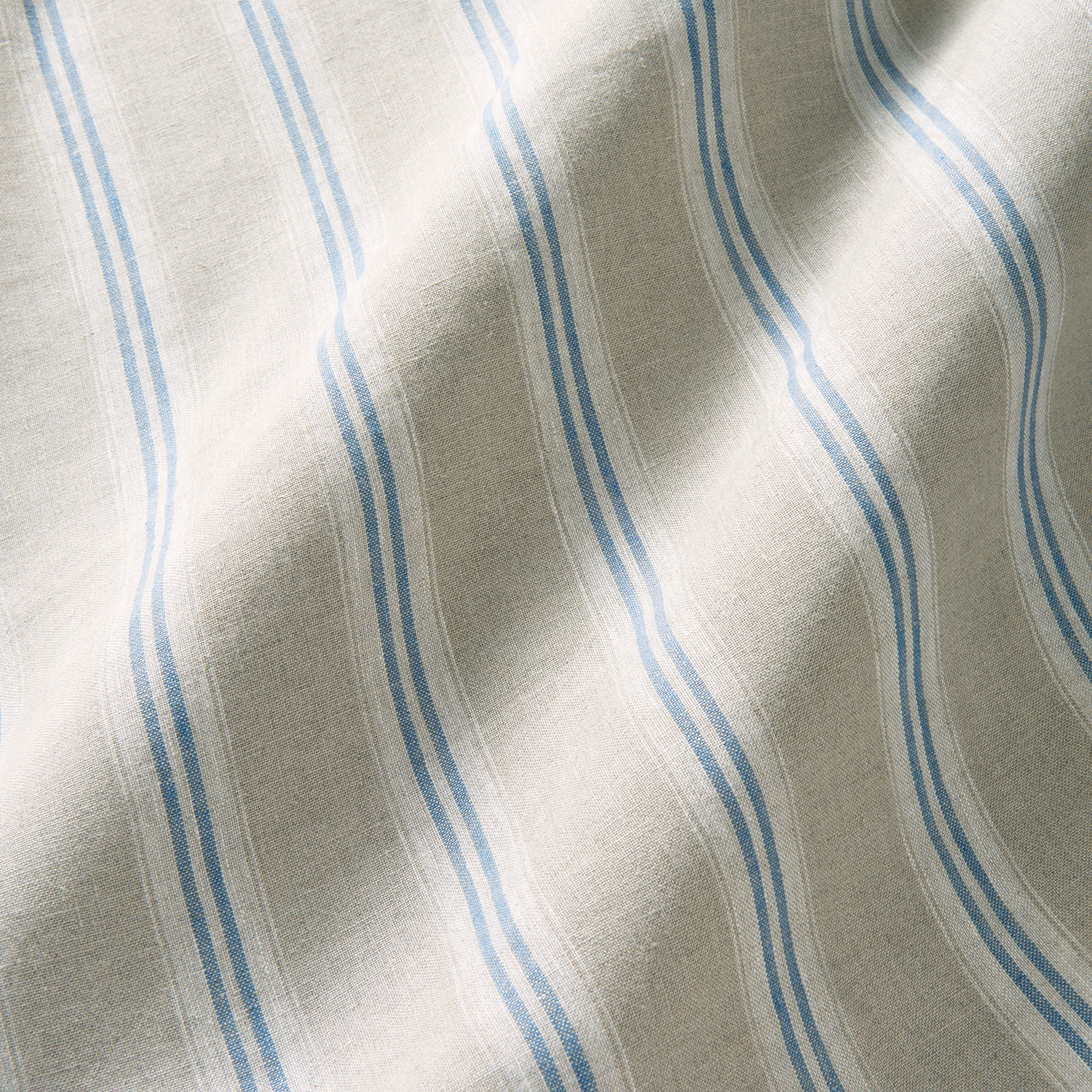 Pale linen with vertical cornflower-blue wavy stripes and soft slub texture