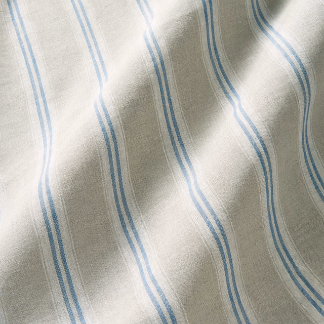 Pale linen with vertical cornflower-blue wavy stripes and soft slub texture