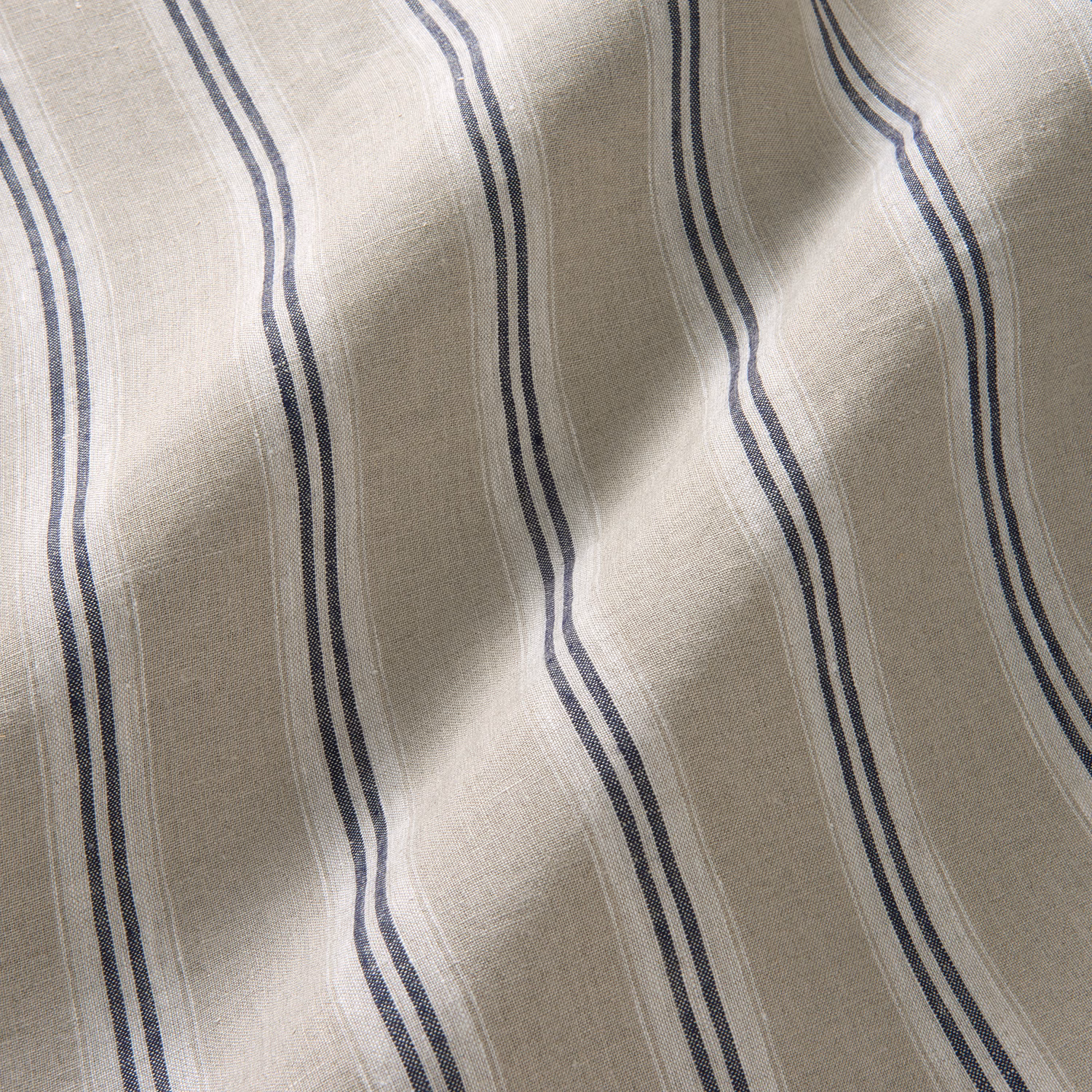 Natural flax linen with wavy indigo double stripes and visible slub texture