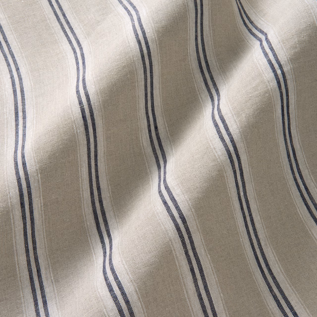 Natural flax linen with wavy indigo double stripes and visible slub texture