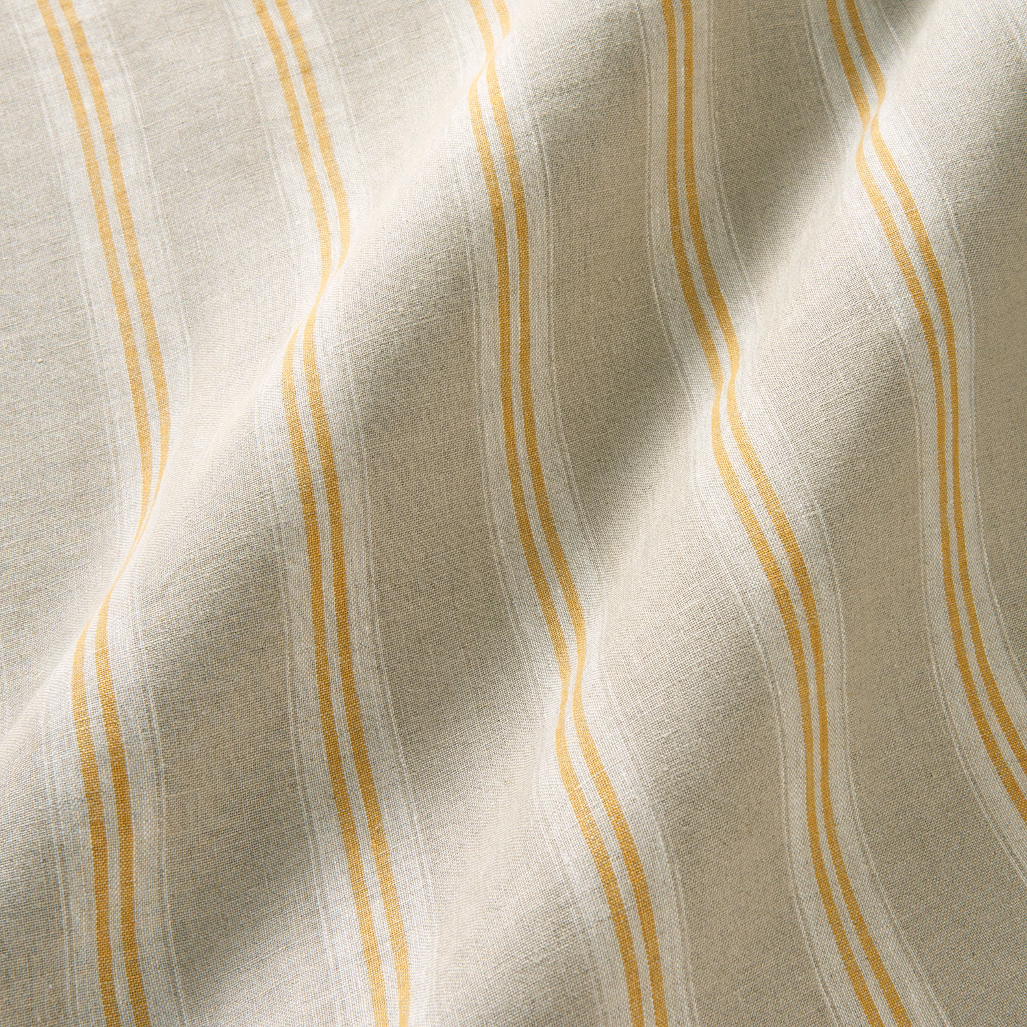 Mellow ivory linen with wavering ochre-orange stripes and softly slubbed texture