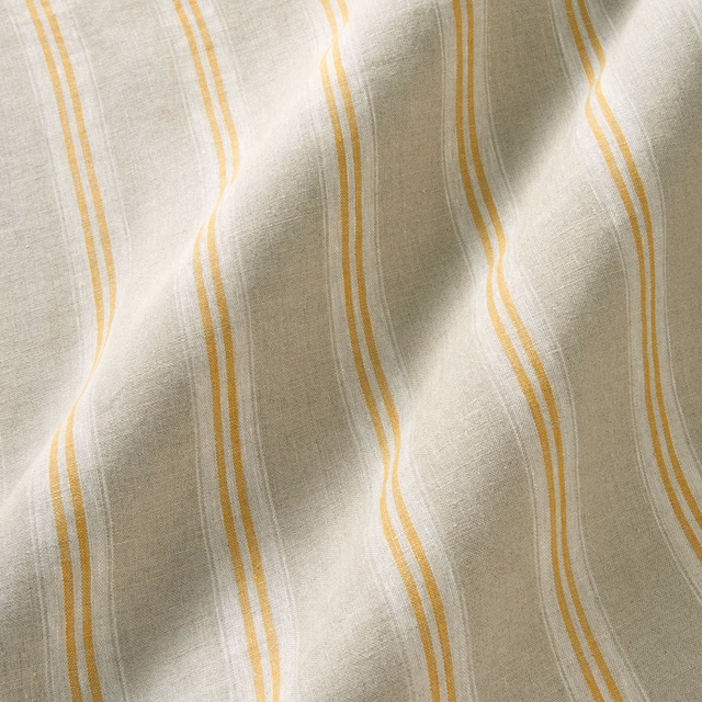 Mellow ivory linen with wavering ochre-orange stripes and softly slubbed texture