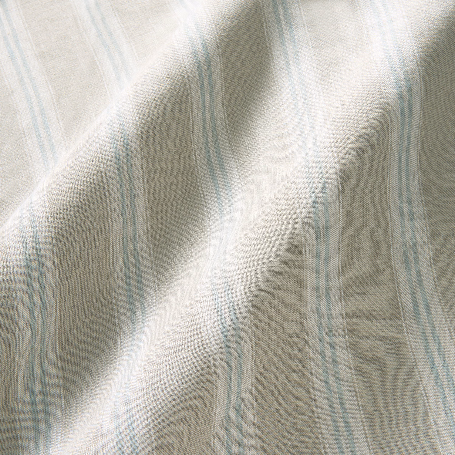 Pale blue and lilac vertical stripes on softly textured natural linen fabric