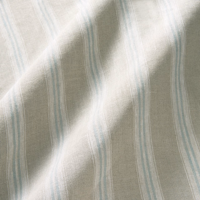 Pale blue and lilac vertical stripes on softly textured natural linen fabric