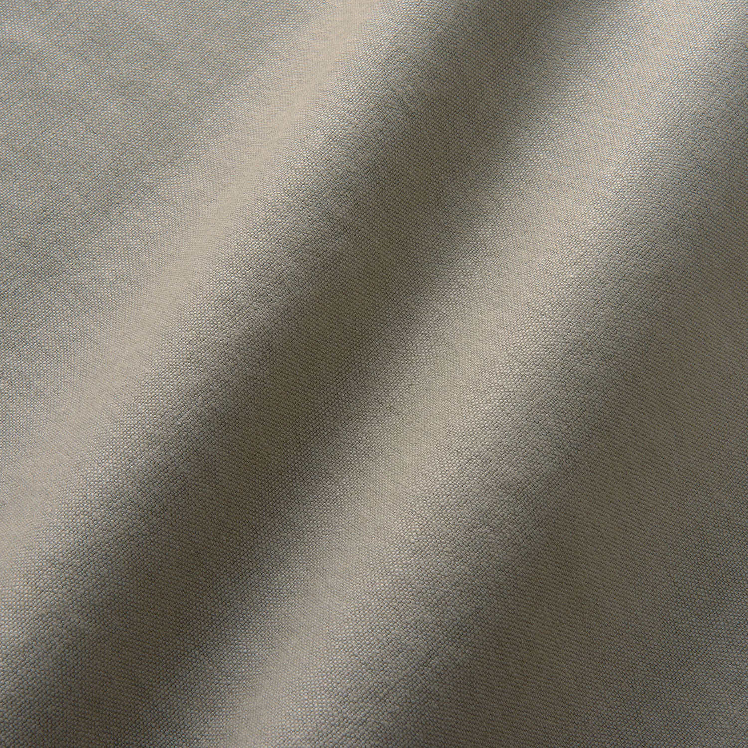 Close-up of cool ash-grey linen with a fine plain weave and shadowed folds
