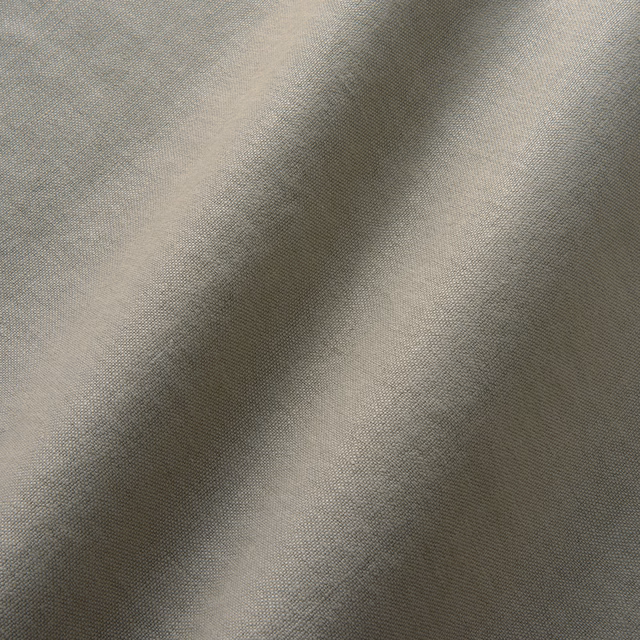 Close-up of cool ash-grey linen with a fine plain weave and shadowed folds