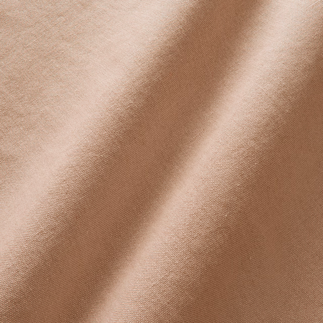 Warm blush-buff linen with fine plain weave and softly folded tonal shading