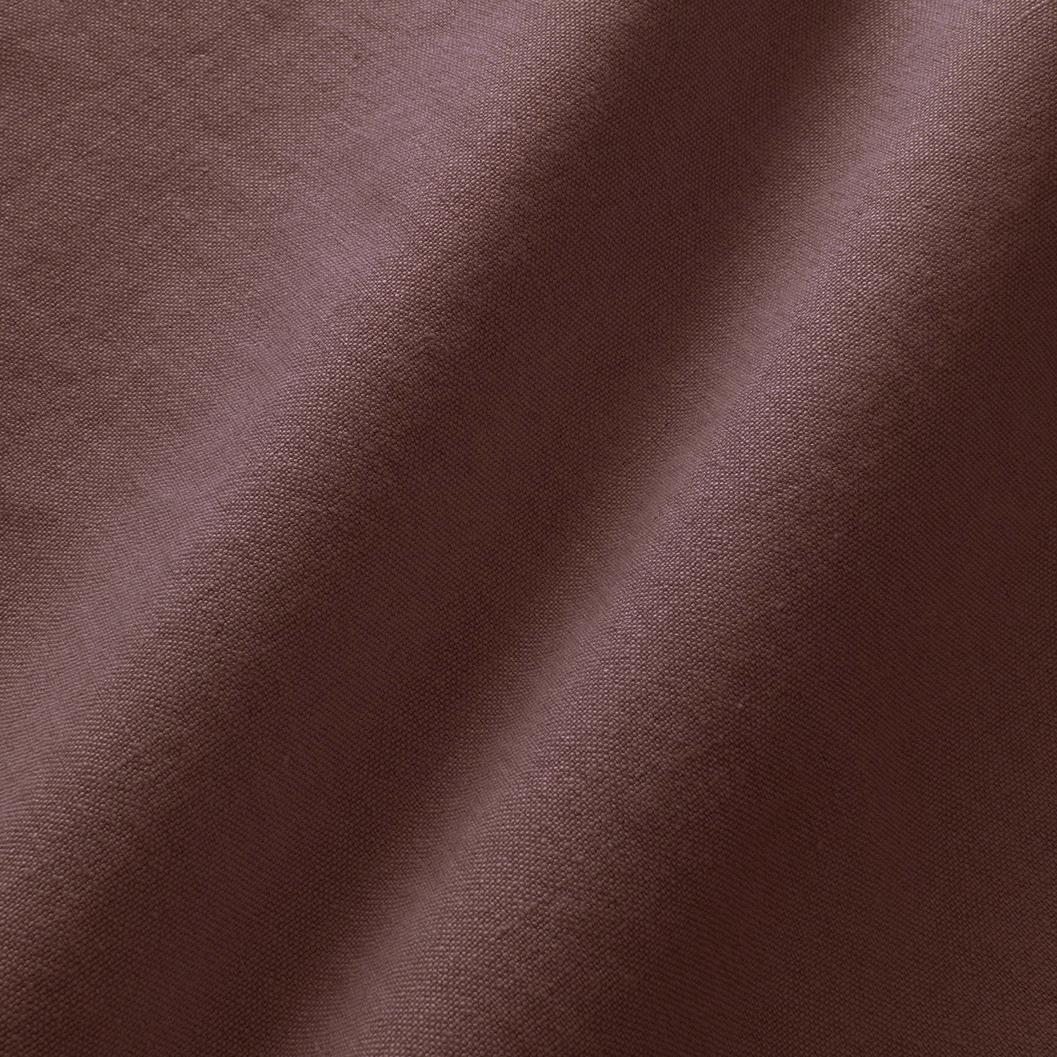 Close-up of deep damson linen with a fine plain weave and soft folds