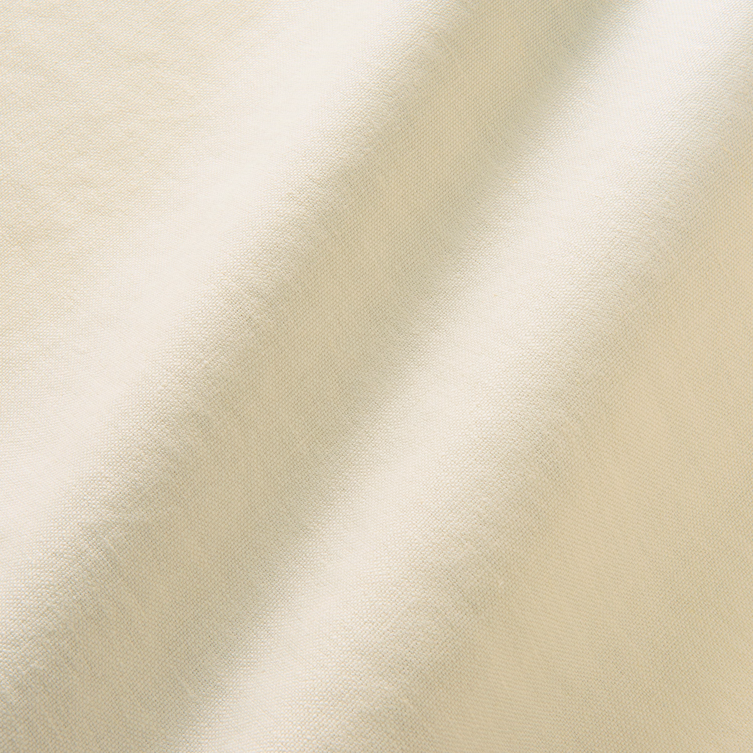 Close-up of warm eggshell linen with fine plain weave and softly mottled cream shading