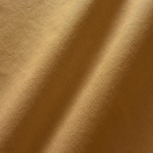 Warm ginger linen with fine plain weave and soft diagonal folds