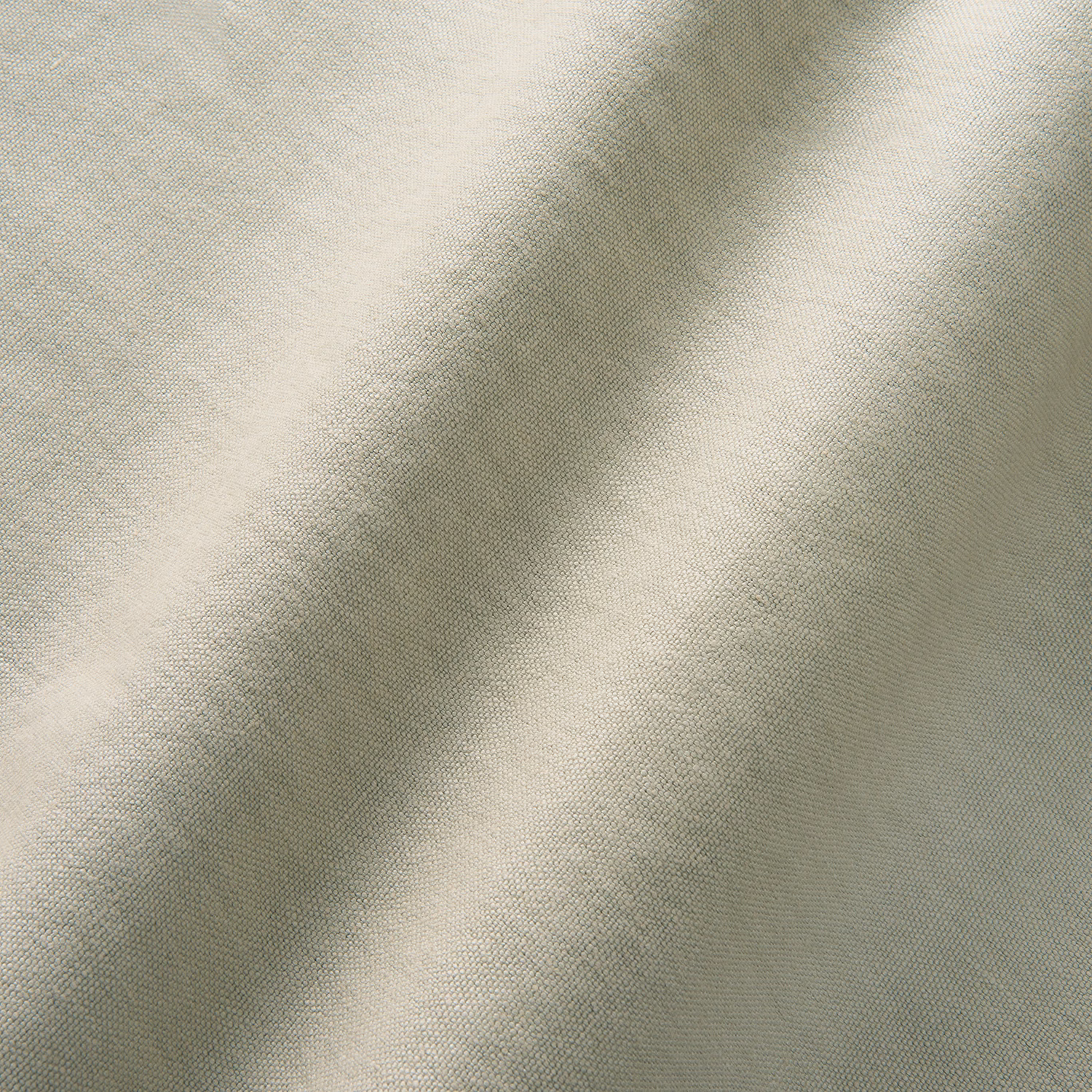 Close-up of pale greige linen weave with soft folds and ivory highlights