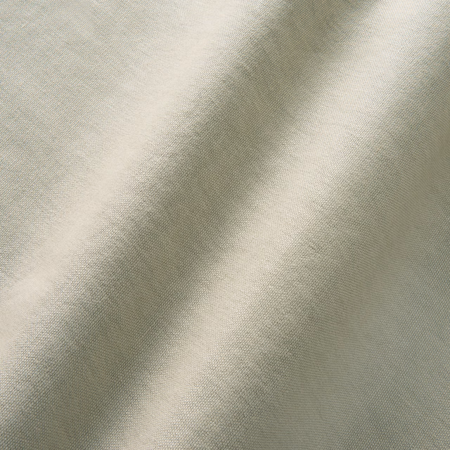 Close-up of pale greige linen weave with soft folds and ivory highlights