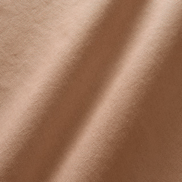 Warm honey-beige linen with a fine plain weave and soft folded highlights