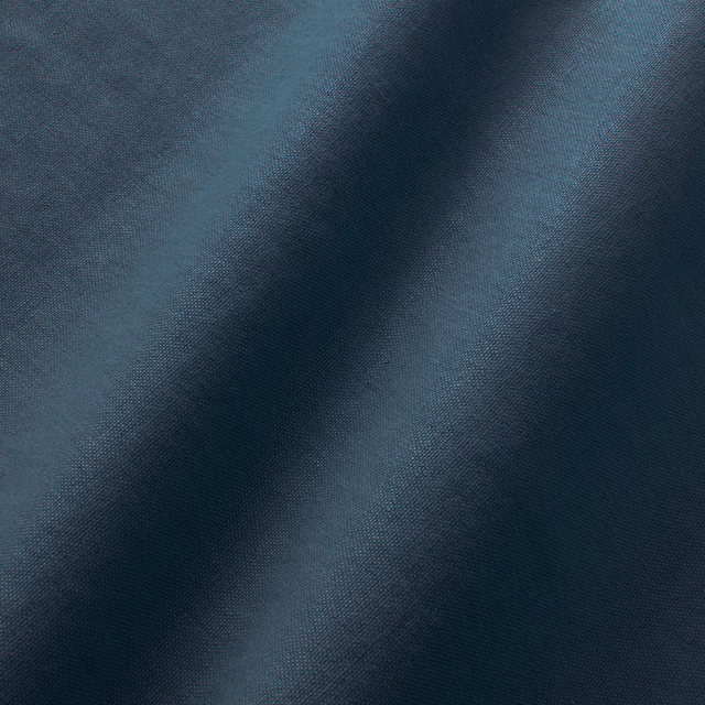 Deep indigo blue linen with fine plain weave and softly shaded folded texture