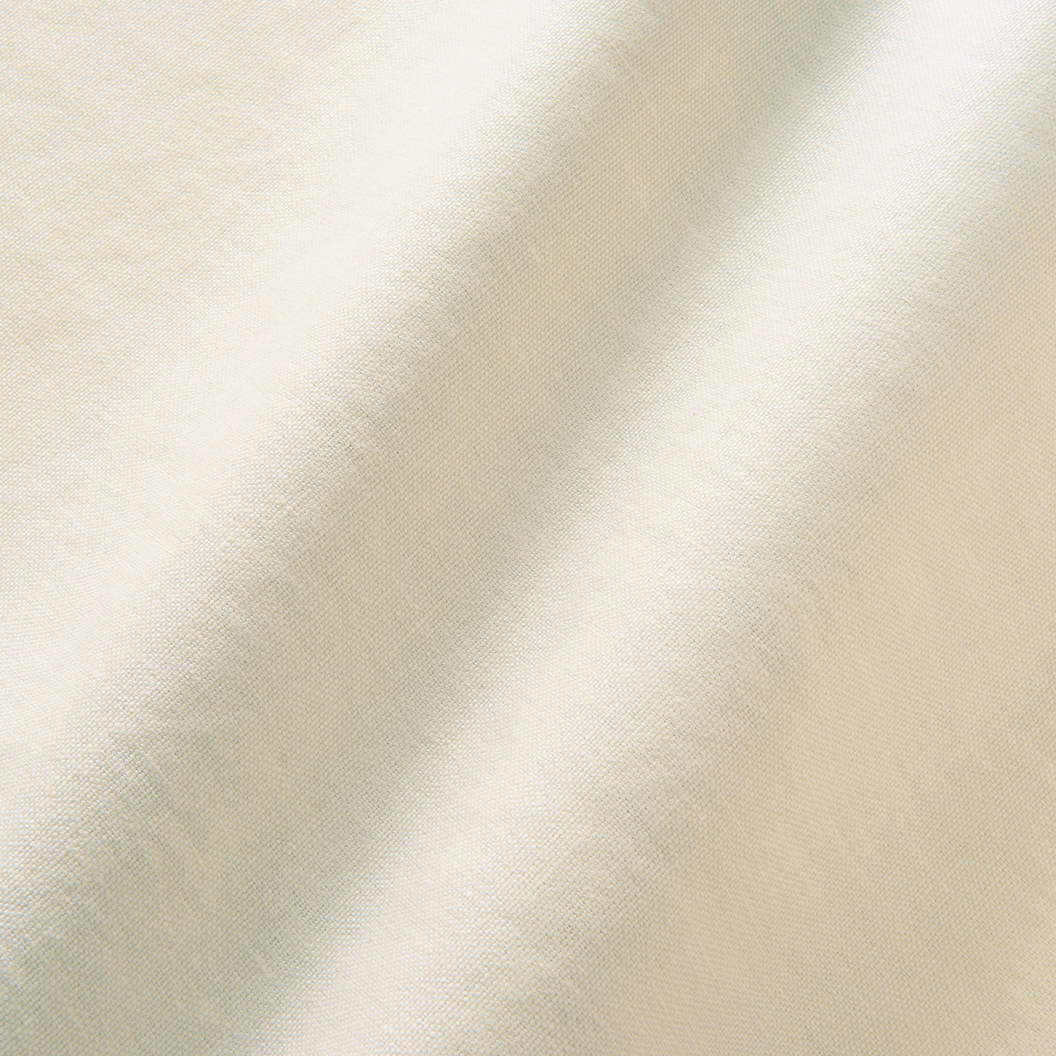 Close-up of warm ivory linen with fine diagonal weave and soft tonal variation