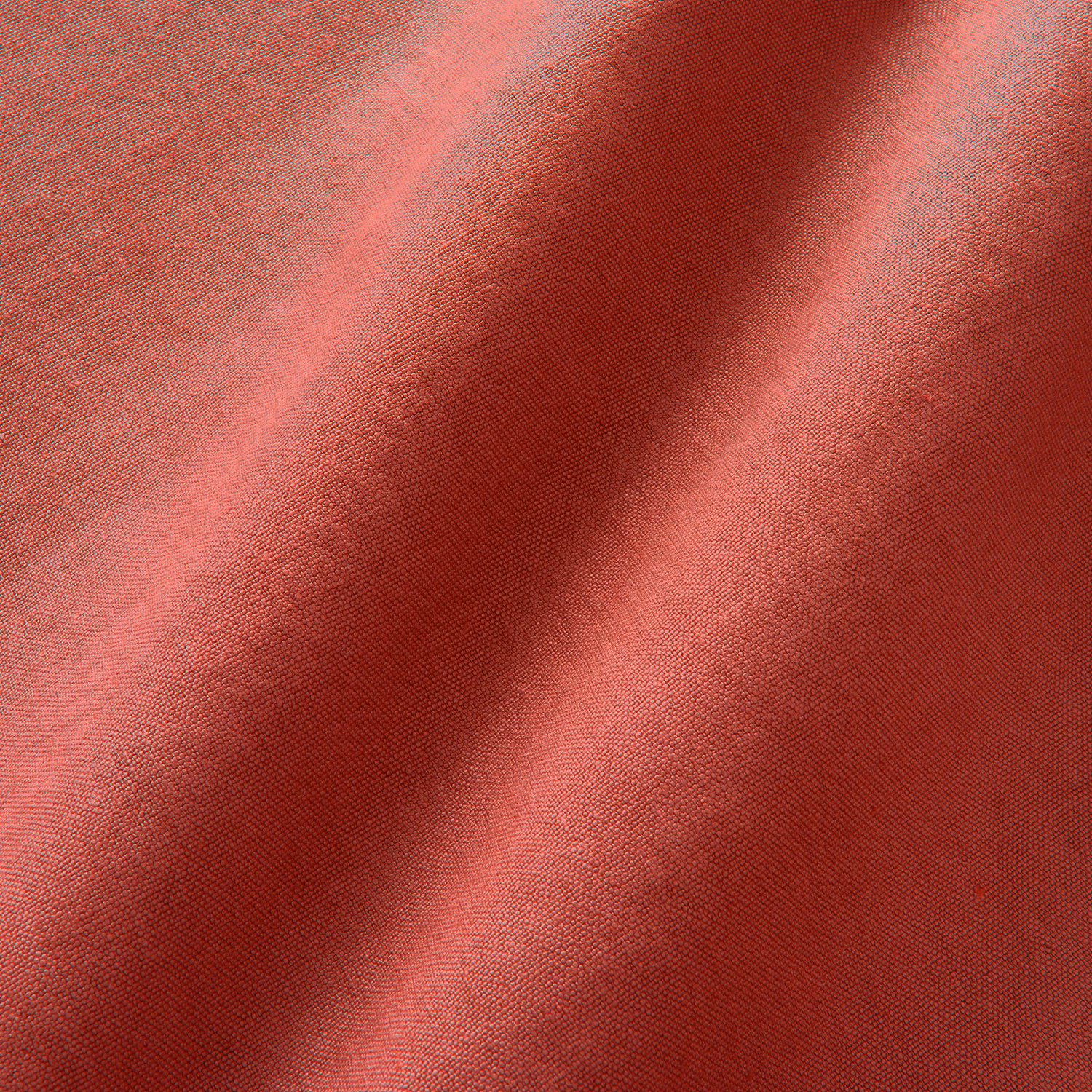 Close view of Elba Lipstick’s fine plain linen weave in layered coral-red folds