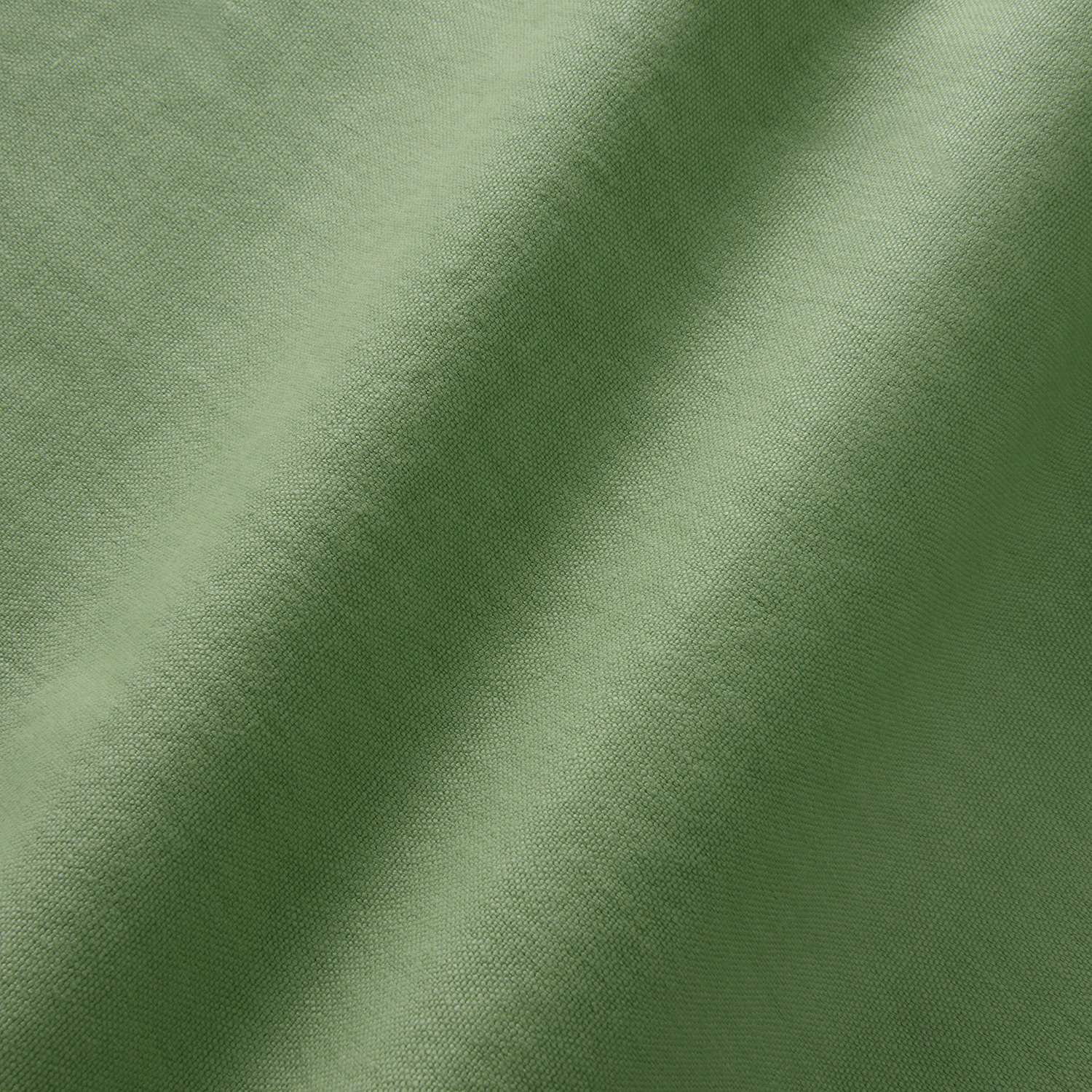 Close-up of muted mantis green linen with a fine softly textured plain weave