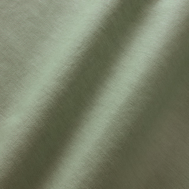 Muted moss-green linen with fine plain weave and softly folded surface