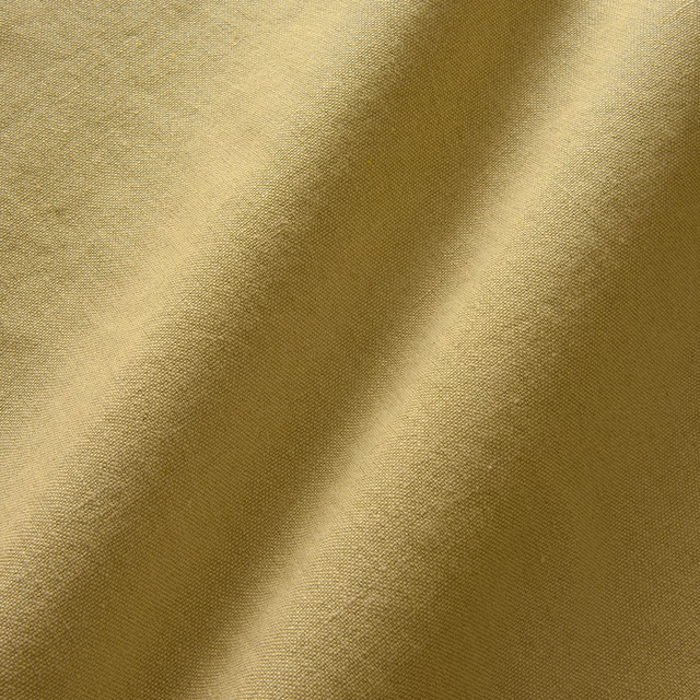 Warm ochre linen with fine plain weave and softly shaded folded highlights