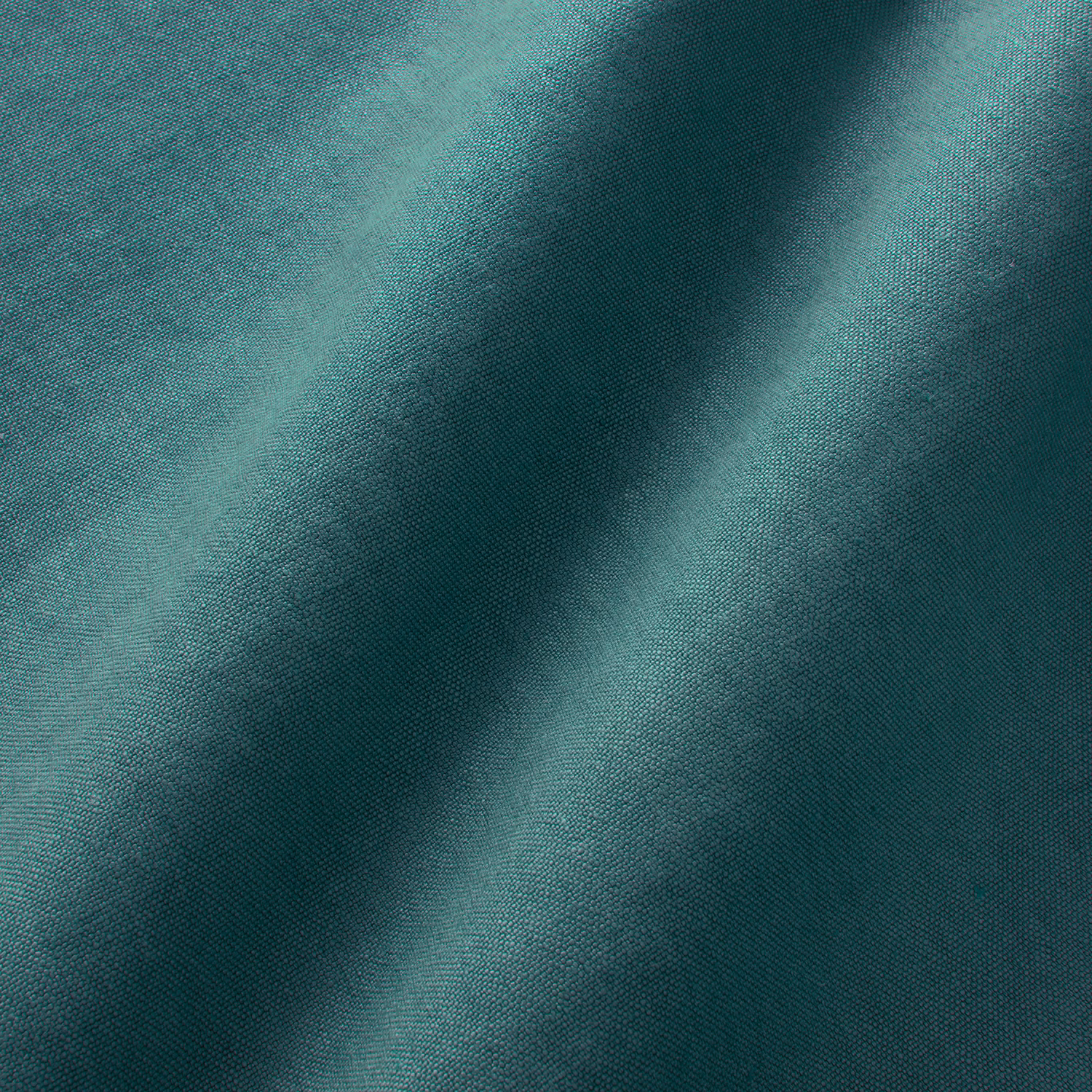 Deep petrol teal linen close-up showing fine weave and softly shifting folded highlights