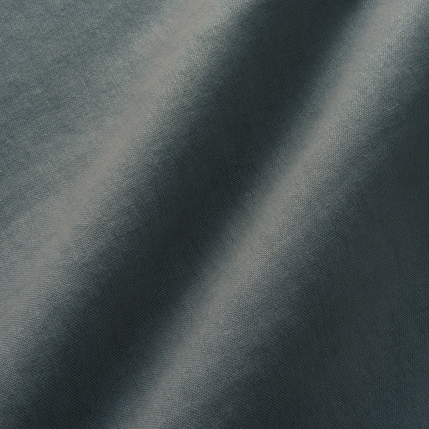 Close-up of cool pewter-grey linen with fine plain weave and smoky tonal folds