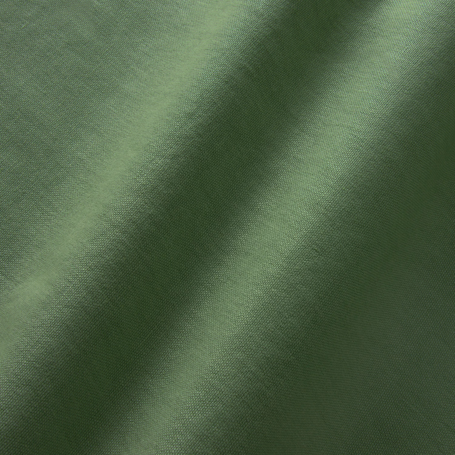 Close-up of Elba Pine linen in a deep, softly mottled pine green weave