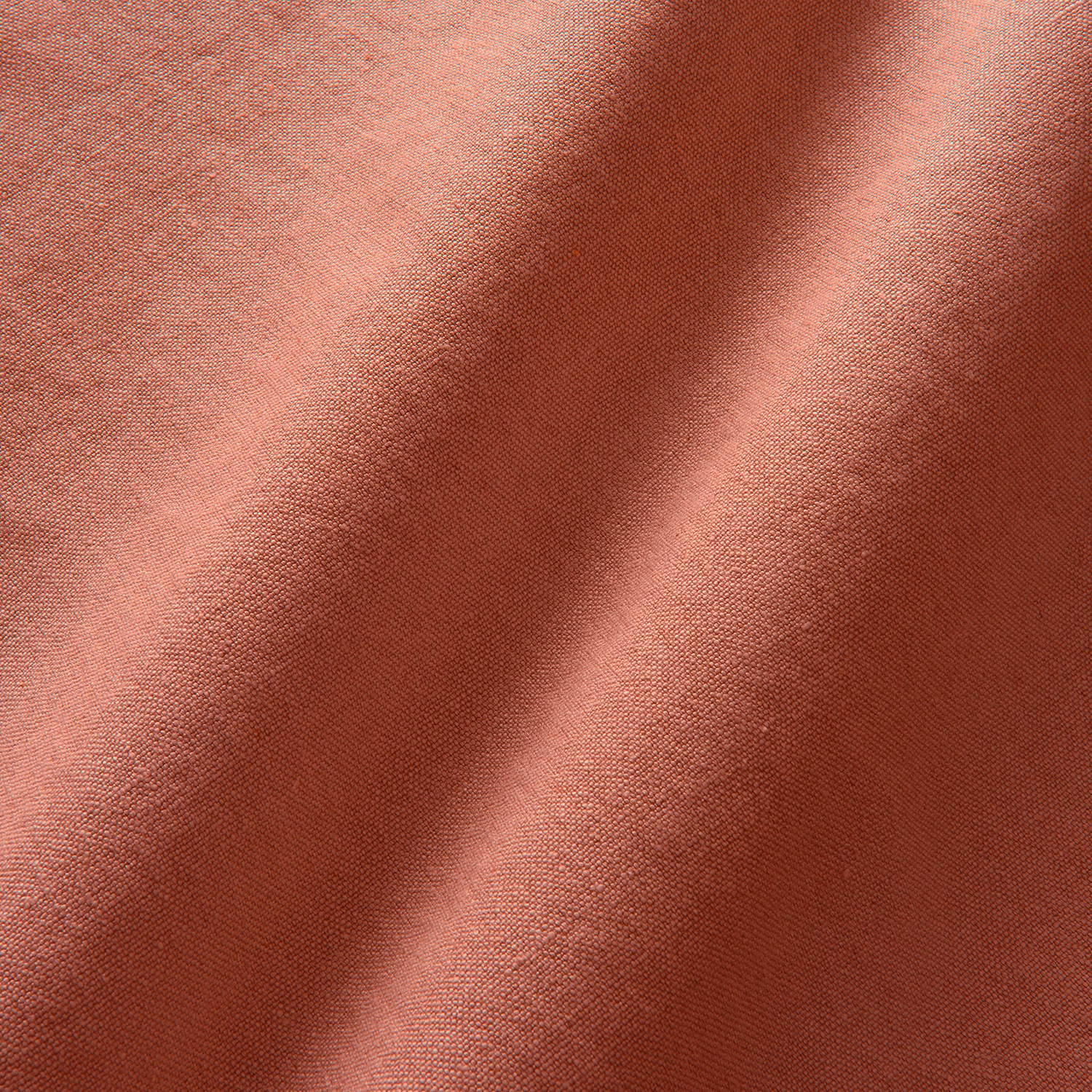 Fine plain linen in dusty rose red with burgundy shading across soft folds