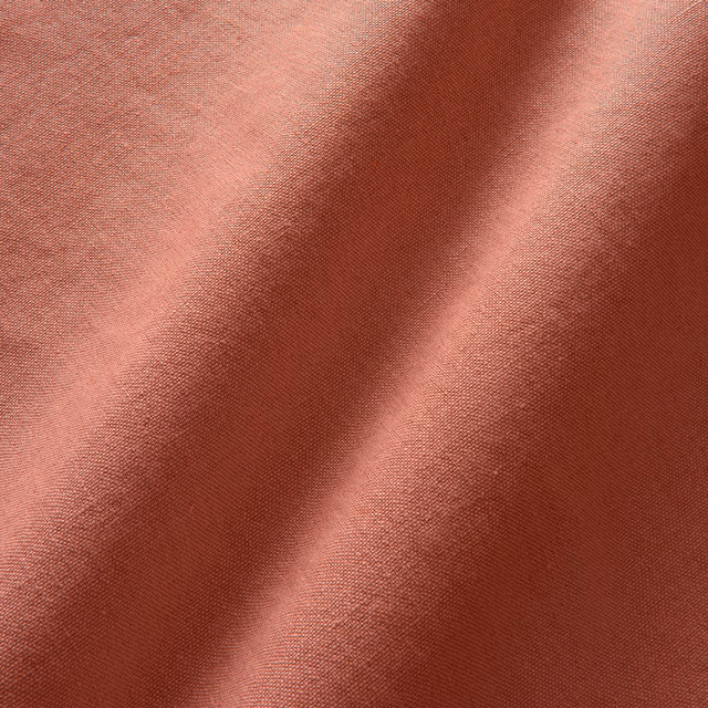 Fine plain linen in dusty rose red with burgundy shading across soft folds