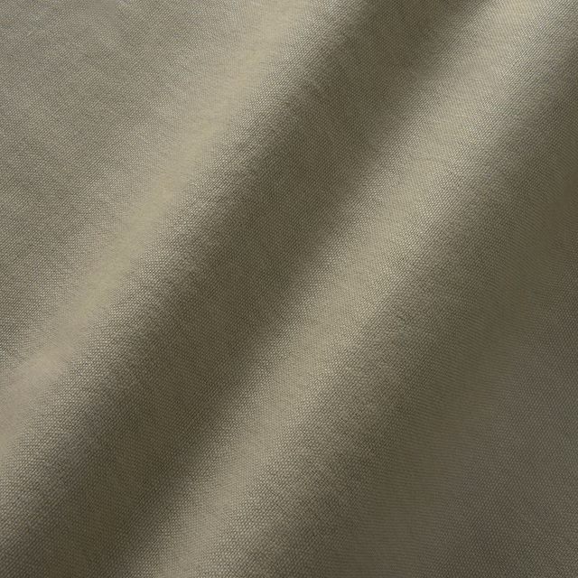 Close-up of muted sage-olive linen with a fine, softly tonal weave