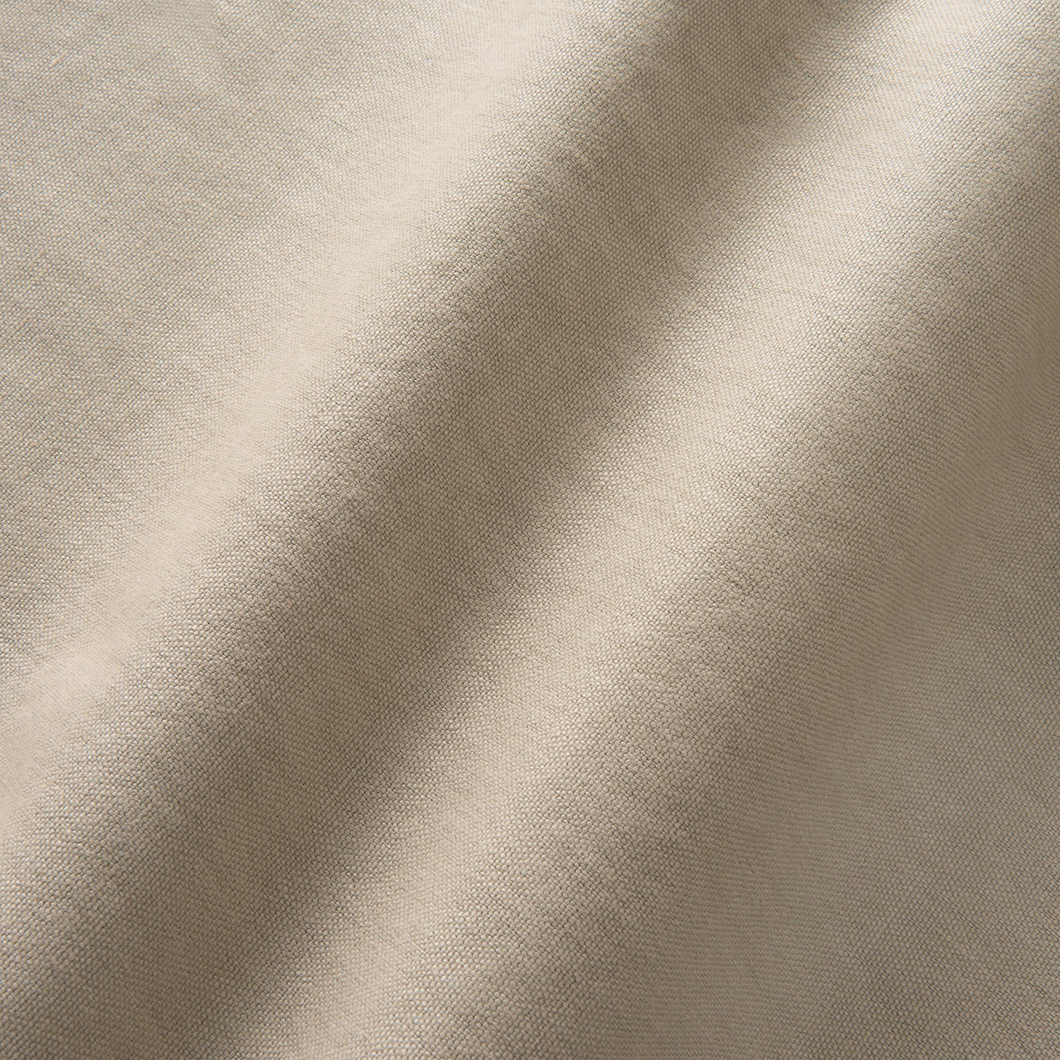 Warm sisal beige linen with fine woven texture falling into soft folds
