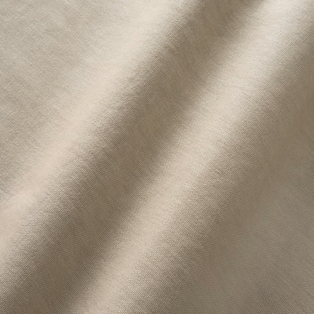 Warm sisal beige linen with fine woven texture falling into soft folds