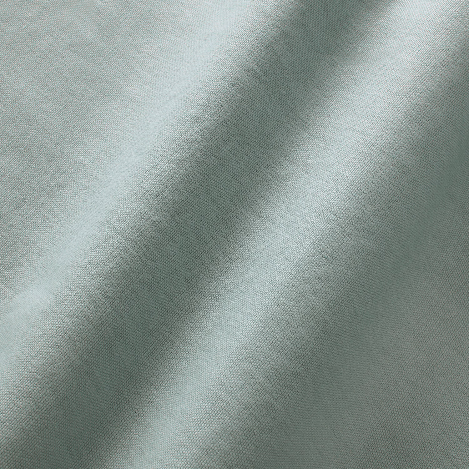 Pale sky-blue linen with fine woven texture and softly folded surface