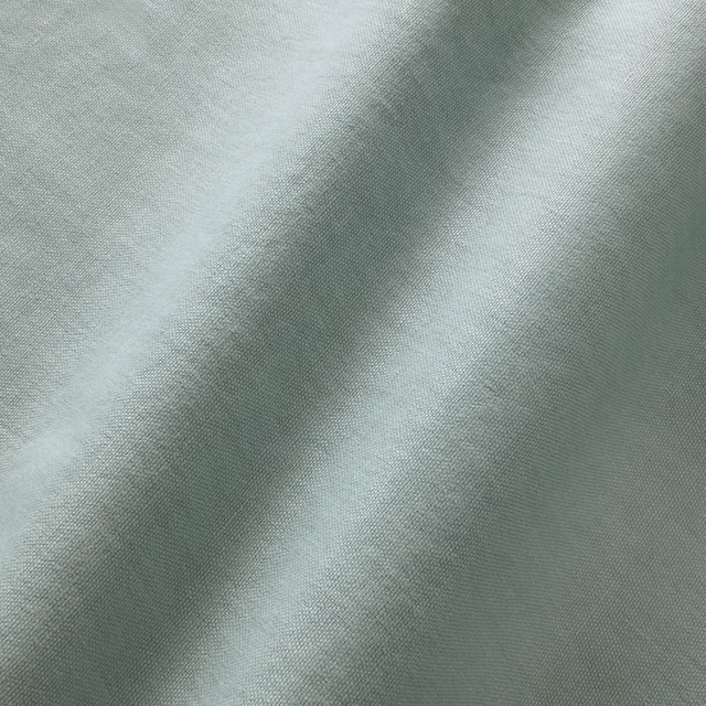Pale sky-blue linen with fine woven texture and softly folded surface