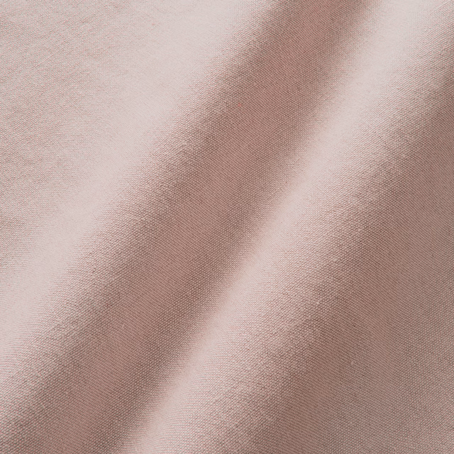 Pale blush pink linen with a fine plain weave and softly shaded folds